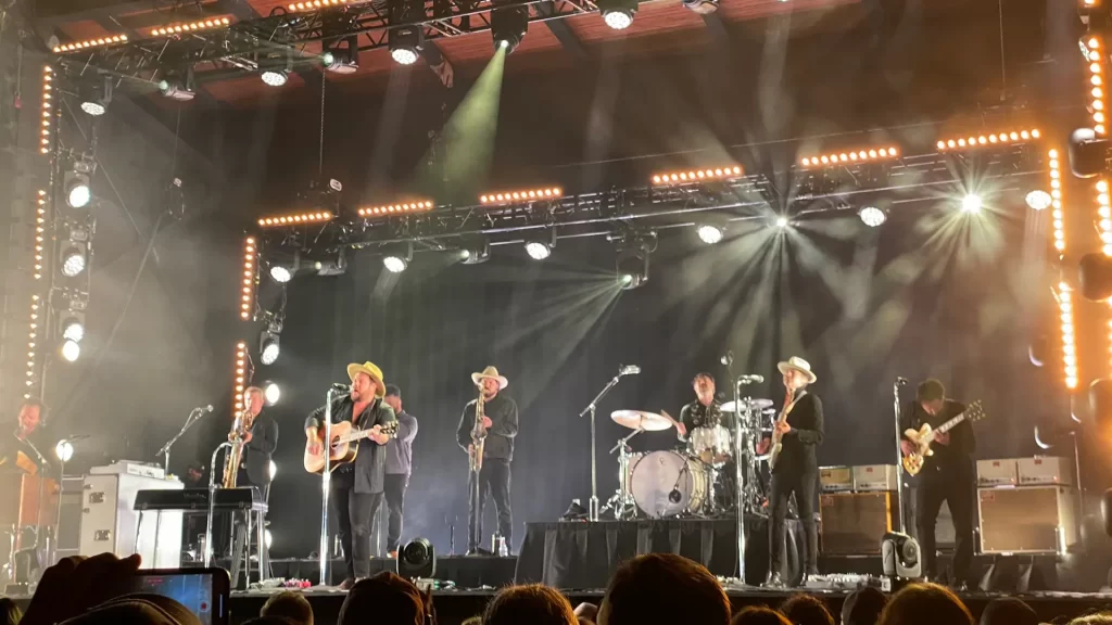 A band performing on stage under bright lights. 